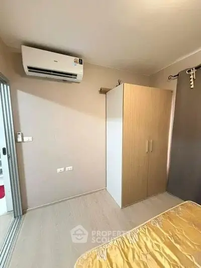 Cozy bedroom with air conditioning and wardrobe, perfect for comfortable living.