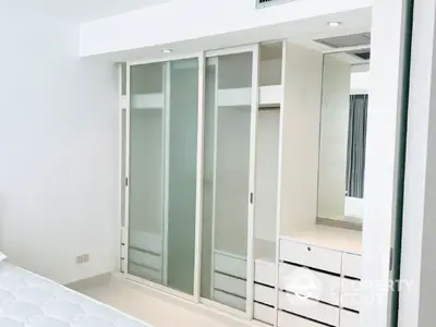 Modern bedroom with sleek built-in wardrobe and minimalist design