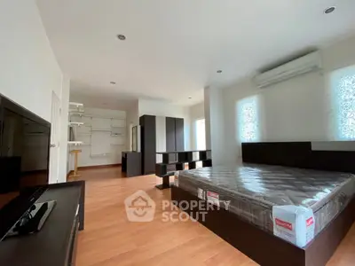 Spacious bedroom with modern furnishings and natural light