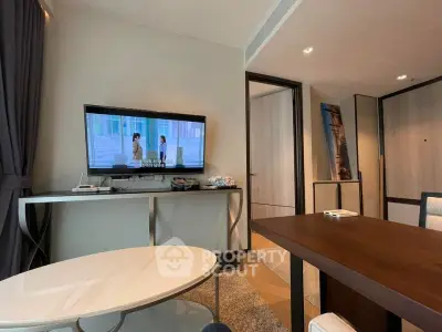 Modern living room with stylish furniture and wall-mounted TV in a cozy apartment.