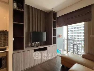 Modern living room with built-in TV unit and balcony view in a stylish apartment.