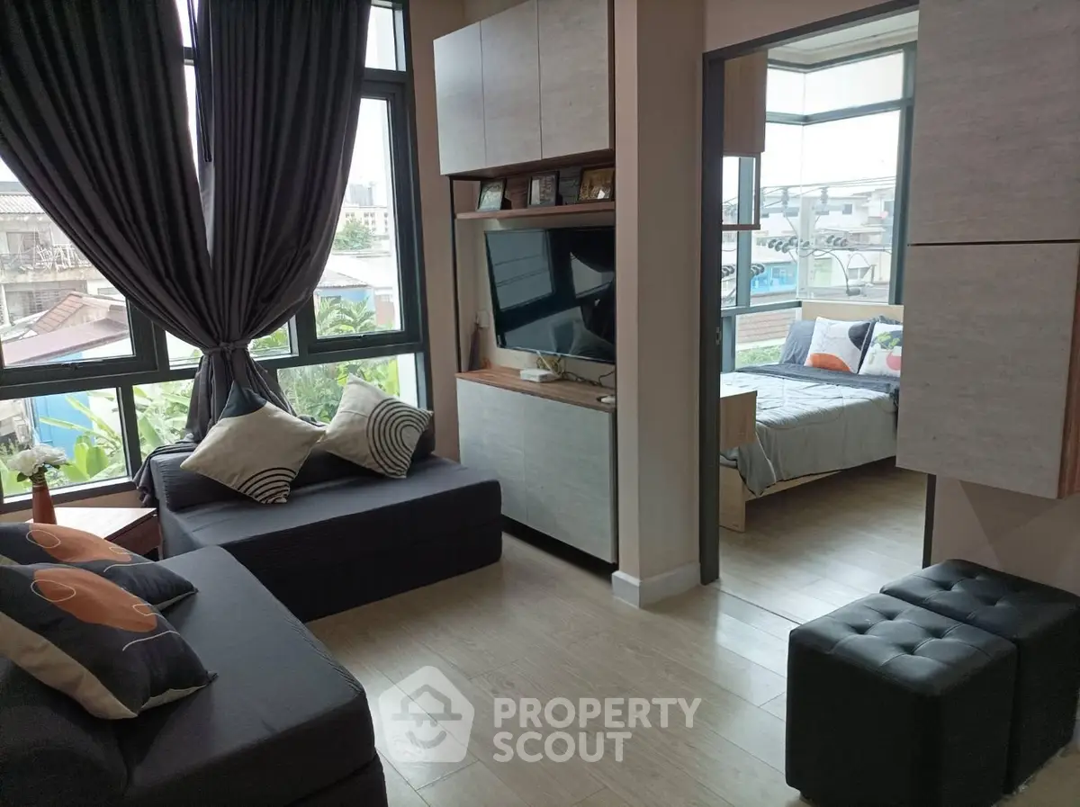 Modern apartment interior with cozy living room and stylish bedroom, featuring large windows and elegant decor.