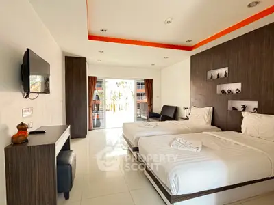 Spacious modern bedroom with twin beds and balcony access in a stylish apartment.