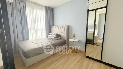 Modern bedroom with stylish decor and large mirror in a cozy apartment.