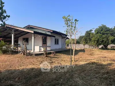 Charming single-story home with spacious yard and covered patio, perfect for outdoor living.