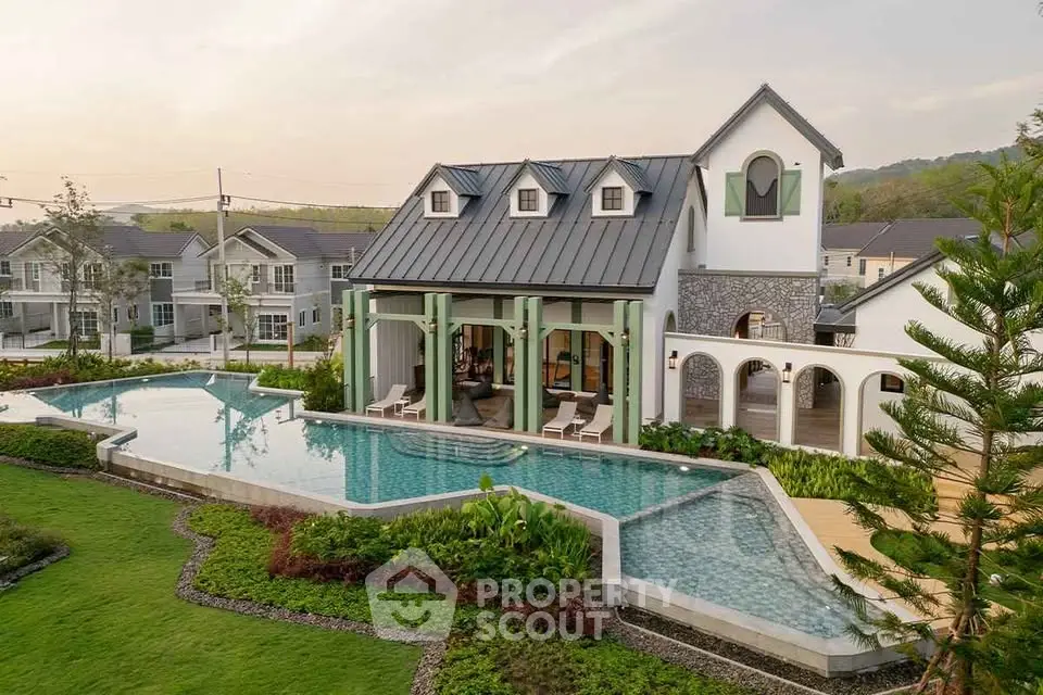 Luxurious modern villa with stunning pool and landscaped garden in serene neighborhood.