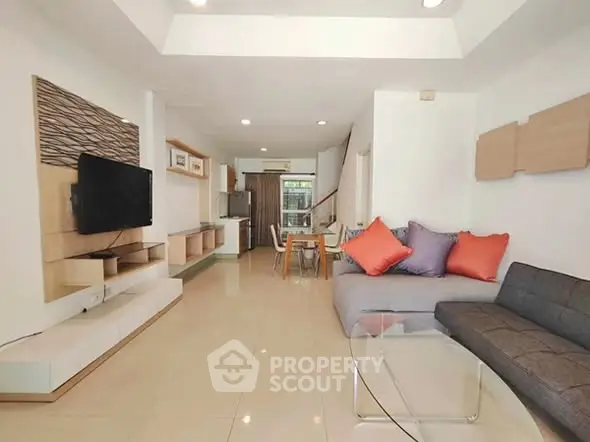 Spacious modern living room with stylish decor and open layout, perfect for relaxation and entertainment.