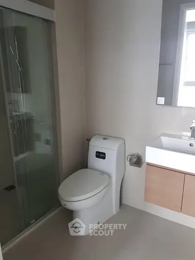 Modern bathroom with sleek fixtures and glass shower enclosure