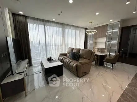 Luxurious living room with panoramic city view and modern furnishings.