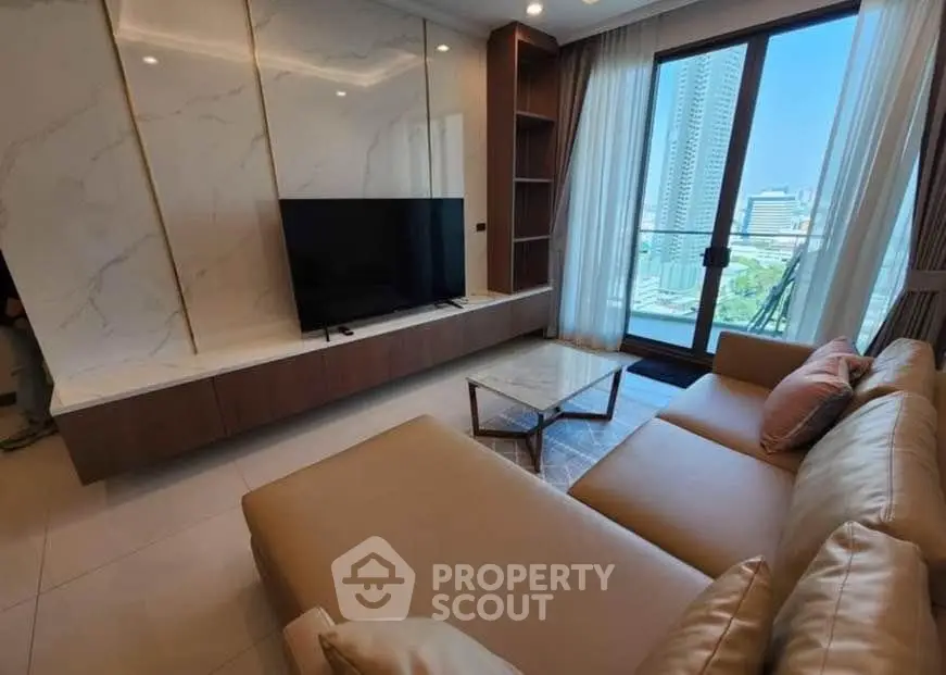 Luxurious living room with modern decor and city view balcony in high-rise apartment.