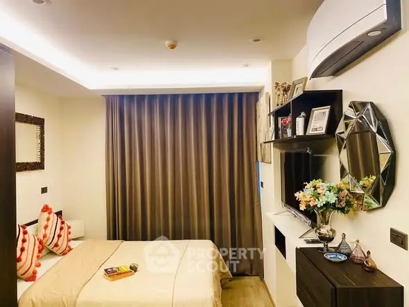 Cozy bedroom with modern decor, featuring a wall-mounted TV and elegant lighting.