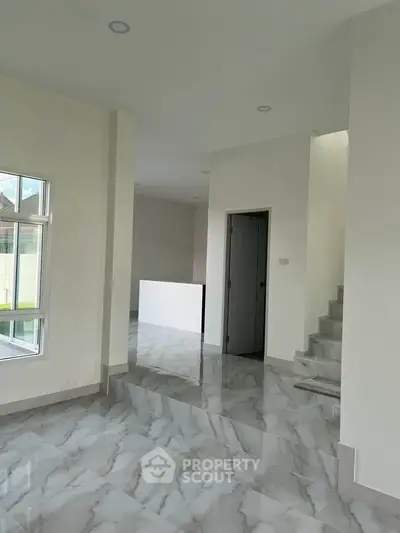Modern interior with marble flooring and staircase in a spacious home
