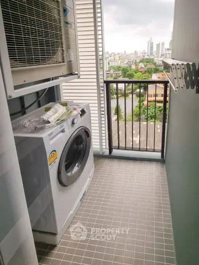 Modern apartment balcony with washing machine and city view, perfect for urban living.