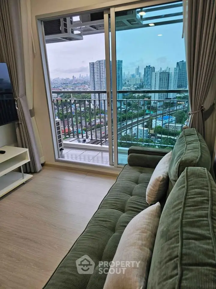 Modern living room with plush sofa and stunning city view from balcony.