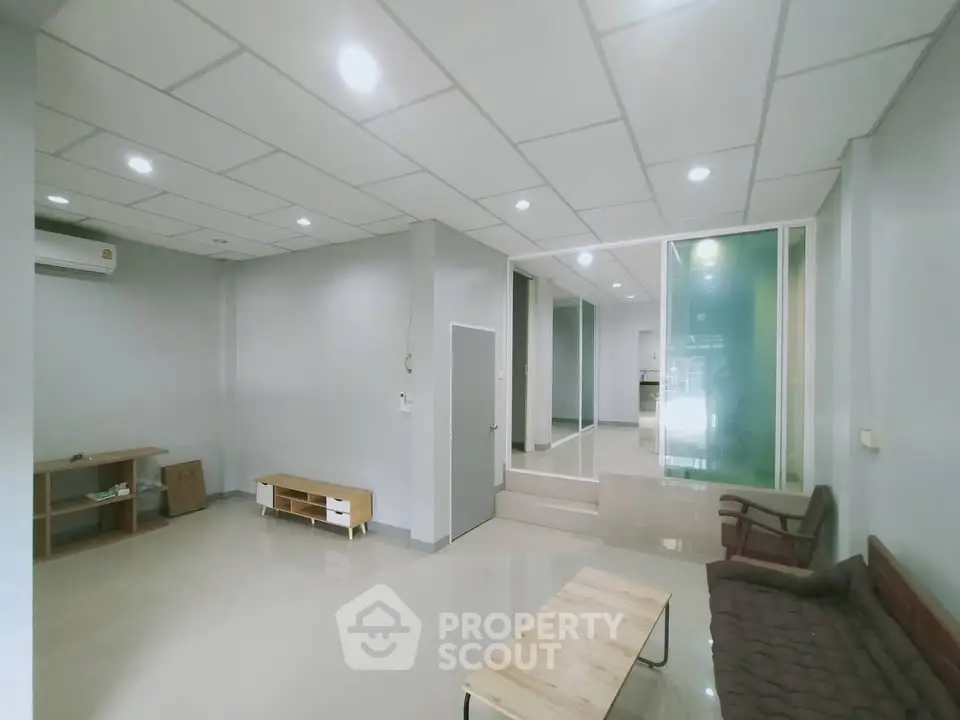 Spacious modern living room with minimalist design and ample natural light.