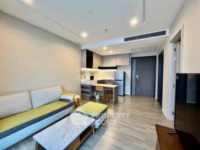 Modern open-layout living room with stylish kitchen and cozy seating area