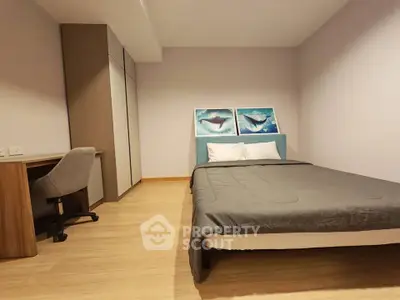 Modern bedroom with minimalist decor and study desk, perfect for a cozy and functional living space.