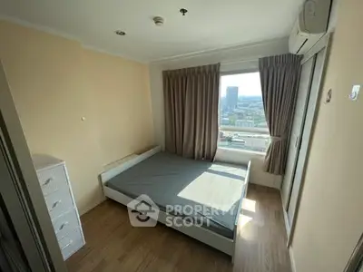 Cozy bedroom with city view, featuring a bed and air conditioning, perfect for urban living.