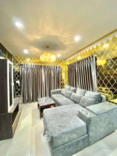 Luxurious living room with plush gray sofa and elegant gold accents