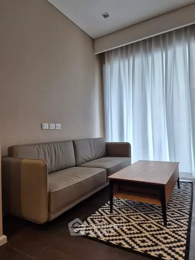 Modern living room with cozy sofa and stylish coffee table near large window.