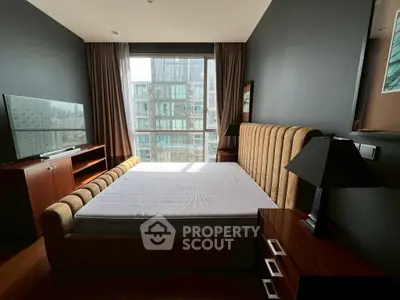 Luxurious bedroom with modern decor and large window offering stunning city views.