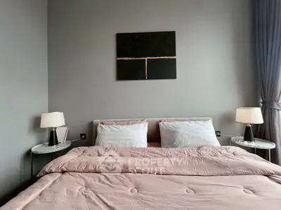 Modern bedroom with stylish decor and cozy bedding in a contemporary apartment.