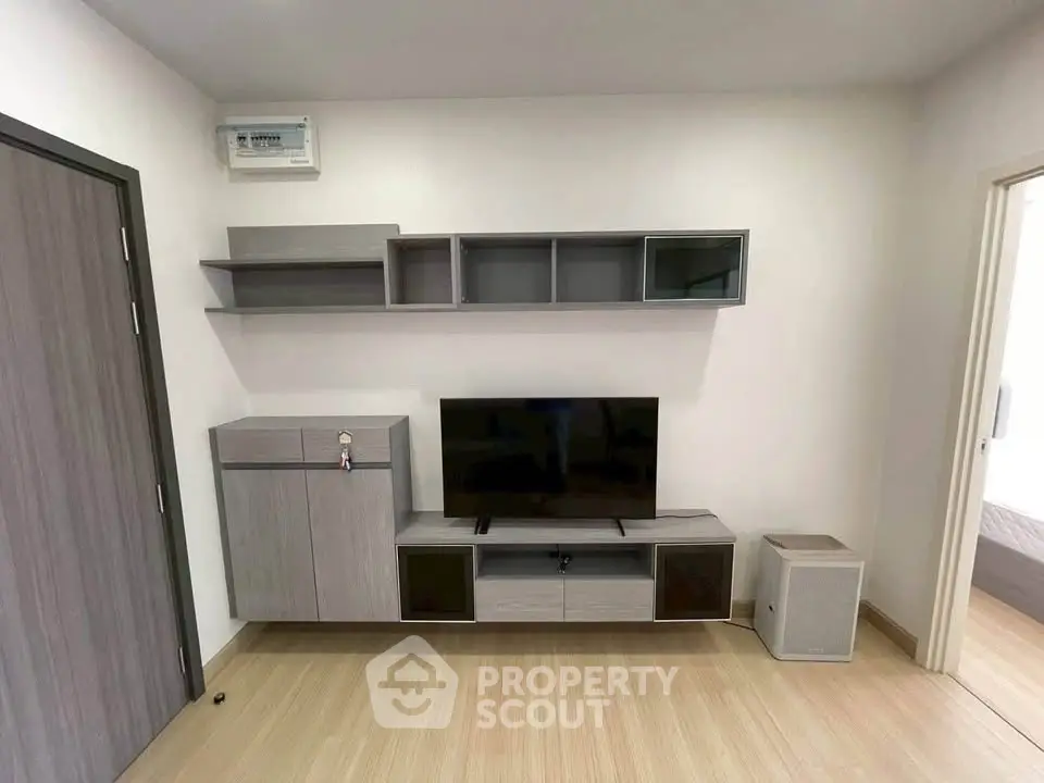 Modern living room with sleek wooden furniture and mounted TV unit