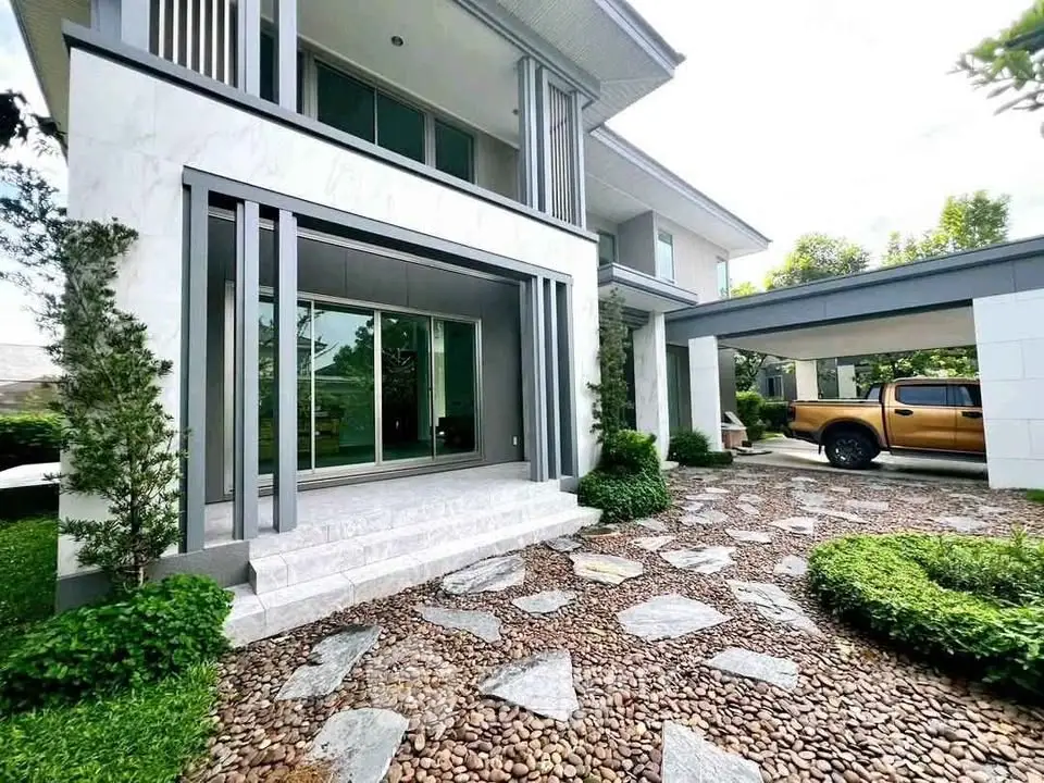 Modern two-story house with landscaped garden and driveway