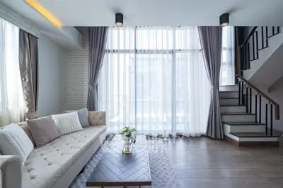 Modern living room with elegant decor and large windows