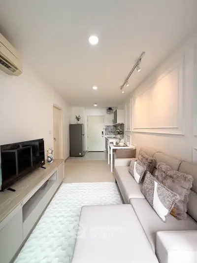 Modern living room with cozy sofa and open kitchen layout