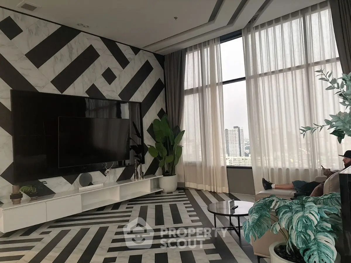 Luxurious modern living room with geometric design and large windows offering city views.