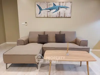 Modern living room with stylish sofa and wooden coffee table, featuring shark artwork on the wall.