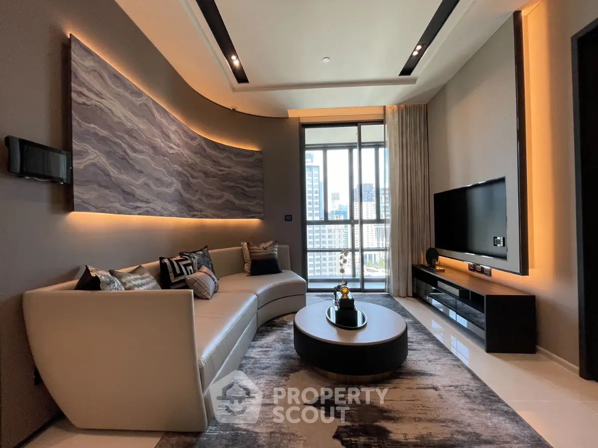 Luxurious modern living room with curved sofa and city view balcony.