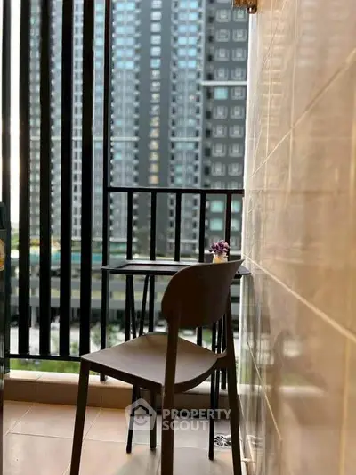 Chic urban balcony with modern seating and cityscape view, perfect for relaxation and enjoying the skyline.