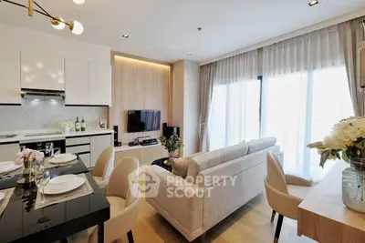 Modern open-plan living room with elegant dining area and sleek kitchen design.