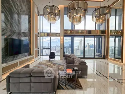 Luxurious high-rise living room with stunning city views and elegant chandeliers.