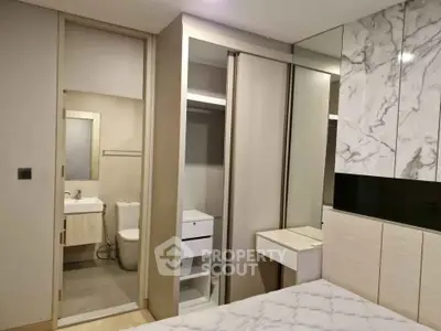 Modern bedroom with ensuite bathroom and stylish marble accents