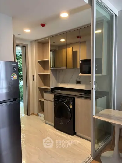 Modern kitchen with sleek appliances and open layout in a stylish apartment