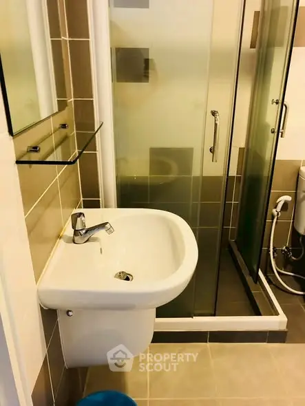 Modern bathroom with sleek sink and glass shower enclosure