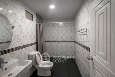 Spacious bathroom with modern fixtures and elegant tile design