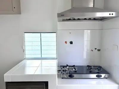 Modern kitchen with sleek gas stove and stainless steel range hood