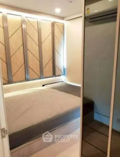 Modern bedroom with stylish paneling and mirrored closet doors