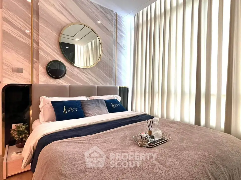Luxurious bedroom with elegant decor and plush bedding in a modern apartment.