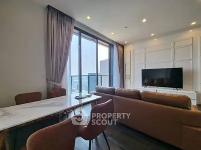 Modern living room with large windows and city view, featuring elegant furniture and stylish decor.