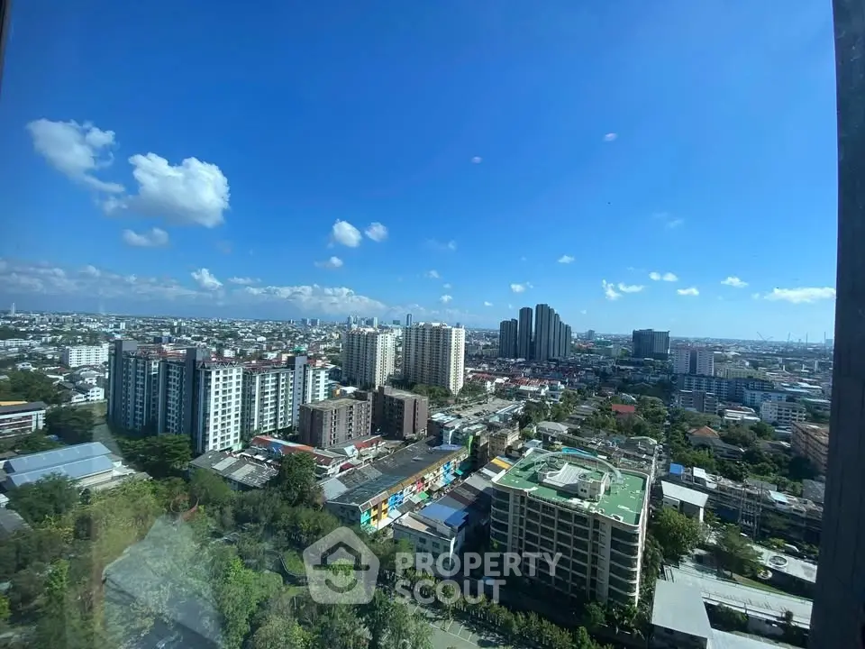 Stunning cityscape view from high-rise building showcasing urban skyline and clear blue sky.