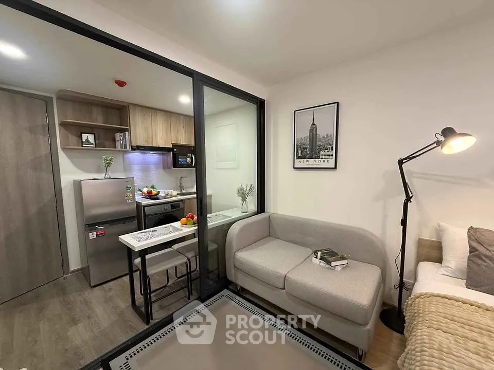 Modern studio apartment with cozy living area and compact kitchen