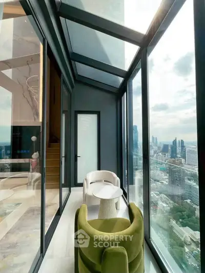 Stunning high-rise balcony with panoramic city views and modern seating area.