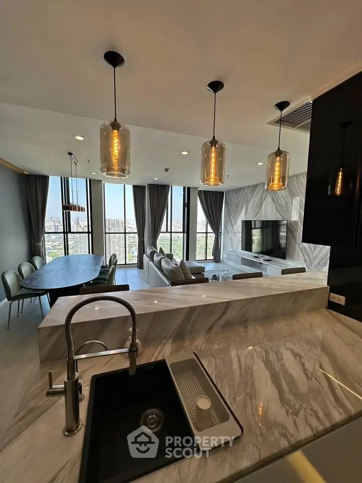 Luxurious open-plan living room with modern kitchen and stunning city view.