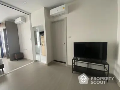 Modern living room with air conditioning and TV setup in a stylish apartment