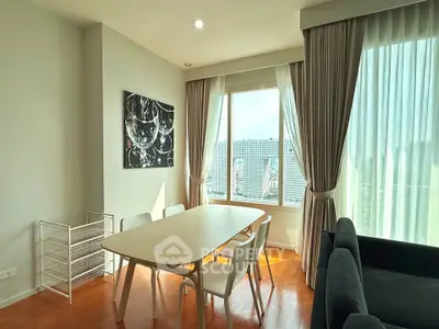 Bright dining area with large window and modern decor